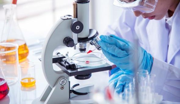 Woman using microscope